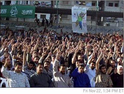 Hamas supporters raise their hands and chant Islamic slogans during a rally in Gaza City cheering the attack
