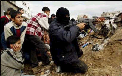 Palestinian fighter taking cover among children. (Reuters)