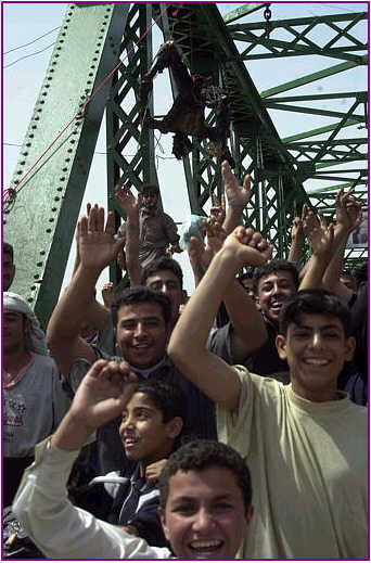 Iraqis celebrate after killing four foreigners in Fallujah	.