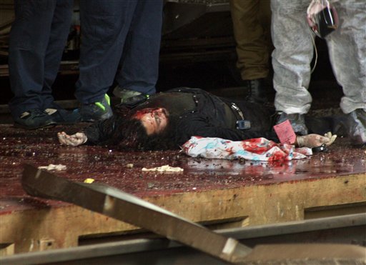 The body of a victim lies at the site of a rocket attack by Hezbollah guerrillas at the train station in the northern Israeli city of Haifa, Sunday July 16, 2006. (AP)