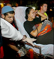 A woman injured in the second blast was rushed to an ambulance.
