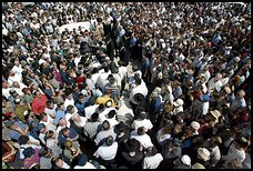 Mourners gather around the bodies of David and Naava Applebaum. Many had come to Jerusalem from abroad to attend Naava's wedding.