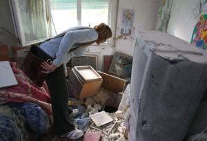 A woman inspects damage to a nursing home in northern Israel after it was hit by a Katyusha rocket yesterday. (AFP/Getty)