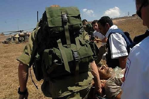 Soldiers evacuating a UN observer wounded by Hezbollah fire in South Lebanon. (Haaretz, July 23, 2006)